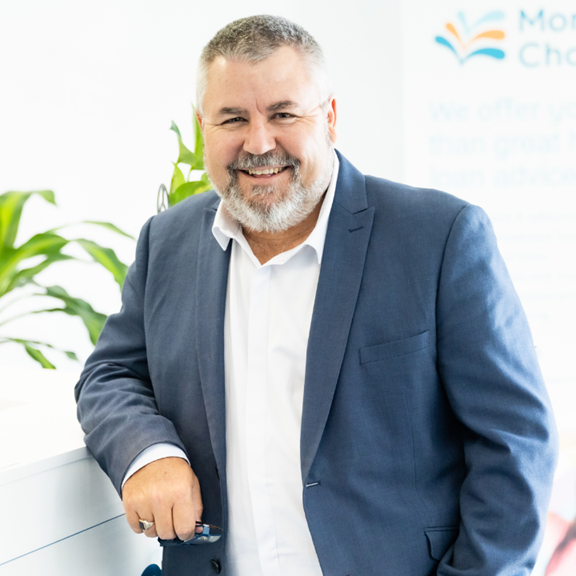 Dwayne Brittain Business Loans Broker leaning on desk